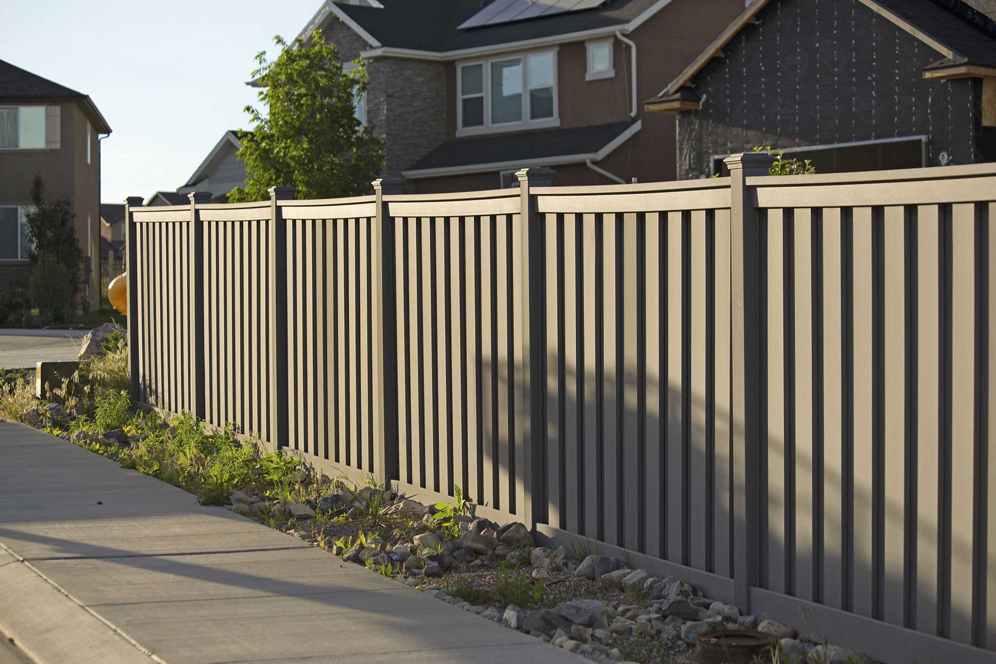 Vinyl fence enhancing front yard curb appeal on a residential property.